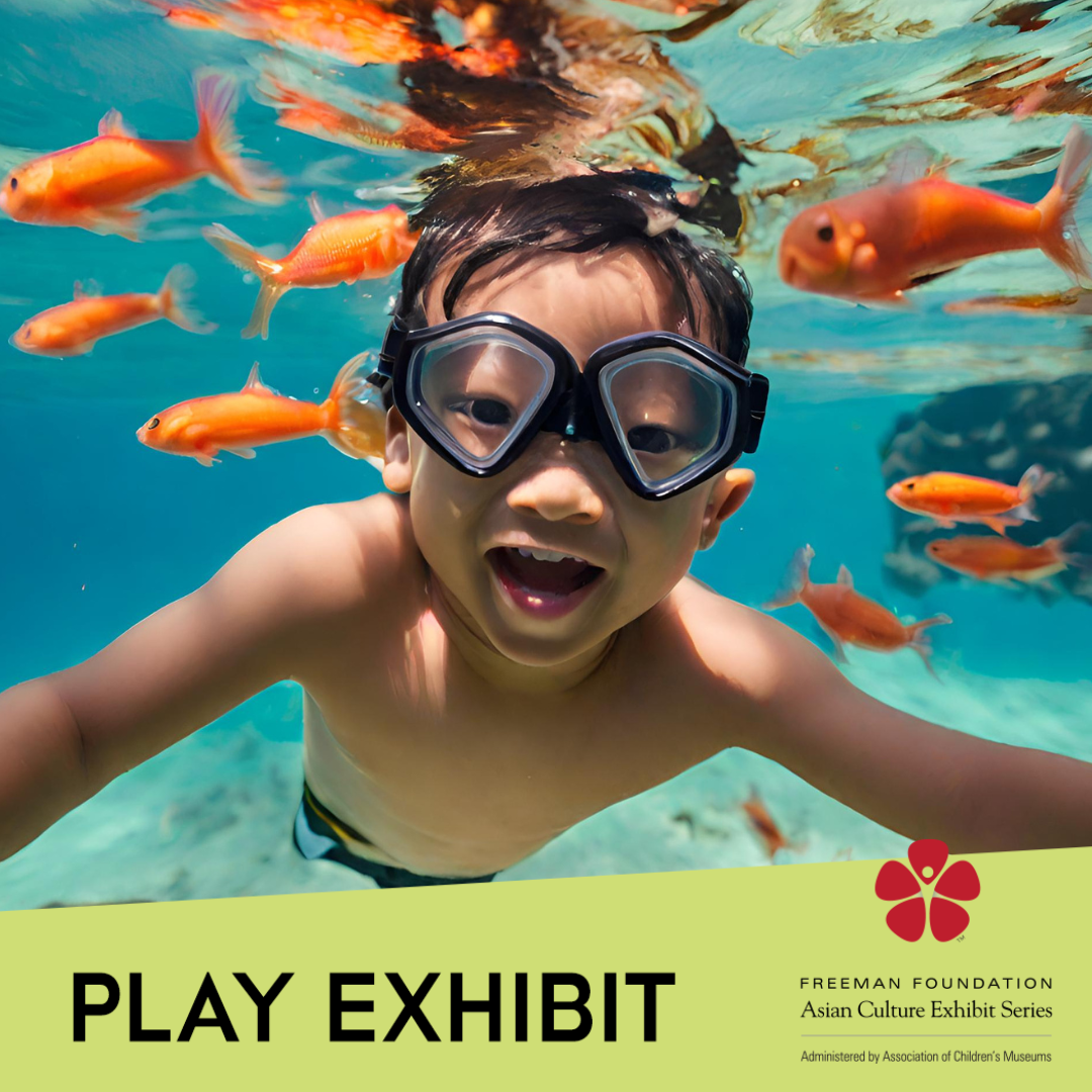 A boy smiles at the camera while swimming with orange fish underwater, all over the text 'Play Exhibit' and the Freeman Foundation Asian Culture Exhibit Series logo